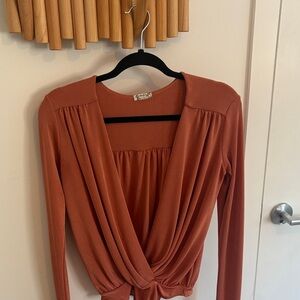 Free People Turnt body suit in colour “mesa”.